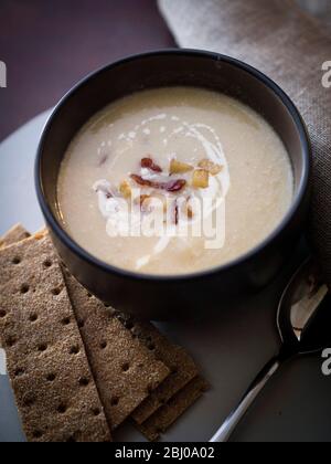 Sellerie und Blauschimmelkäse Suppe mit Beilage aus gebratenem Pancetta und Äpfeln Stockfoto