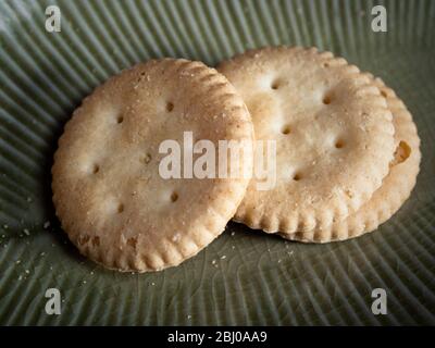 Gluten-freie Snack-Cracker auf grünen Teller Stockfoto