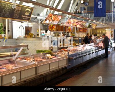 Das Innere der "Feske Kšrka" (Fischkirche), dem wichtigsten Fischmarkt in Göteborg, Schweden, zeigt Fischstände und Käufer. - Stockfoto