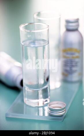 Zwei Gläser eisigen Wodkas mit Flaschen in der Nähe - Stockfoto