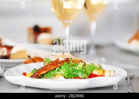 Leckerer Salat mit servierten Weinen Stockfoto