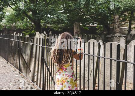 London/UK-22/07/18: Eine Frau fotografiert die Grabsteine in Bunhill Fields, einem ehemaligen Begräbnisplatz im Zentrum Londons. Sie enthält die Stockfoto
