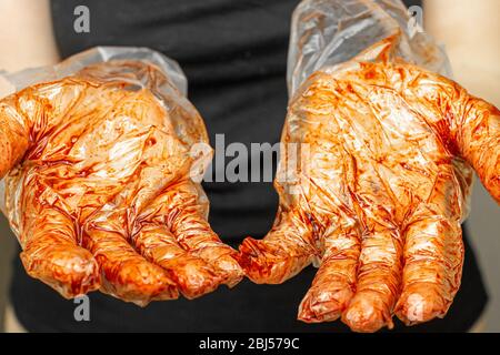 Hände in Handschuhen färben sich mit Farbstoff. Stockfoto