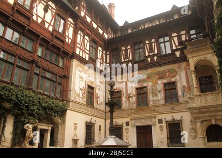 Schloss Peles, Rumänien. Innenhof mit Fachwerkfassaden und handbemalten Wandgemälden. Stockfoto