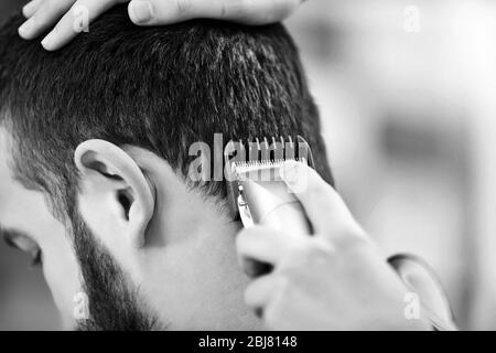 Professionelle Friseur Herstellung stilvolle Frisur für Mann, in schwarz und weiß getönte Stockfoto