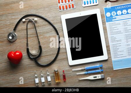 Arzttisch mit Medikamenten und Tablette, Draufsicht Stockfoto