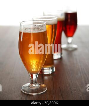 Gläser mit verschiedenen Arten von Handwerk Bier auf Holztisch Stockfoto