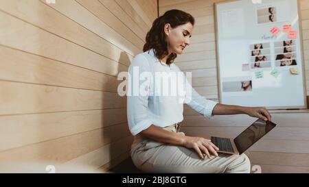 Geschäftsfrau, die am Laptop arbeitet. Weibliche Führungskraft mit Laptop im Kreativbüro. Stockfoto