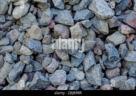 Großer Schotter Hintergrund. Grauer Kies für die Bauindustrie. Nahaufnahme. Blick von oben. Selektiver Fokus. Stockfoto