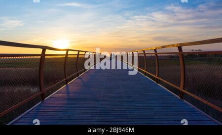 Hortobagy Ungarn 04 20 2019: Touristen fotografieren auf der Holzbrücke bei schönem Sonnenuntergang. Stockfoto