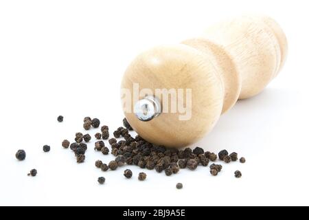 Pfeffermühle aus Holz mit Pfefferkörnern und gemahlener Pfeffer Stockfoto