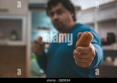 Nahaufnahme Von Männlichen Hand Hält Wurst In Kamera Stockfoto