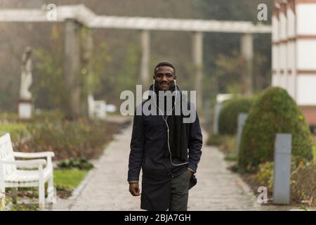 Selbstbewusster junger schwarzer Mann, der im Park unterwegs ist Stockfoto