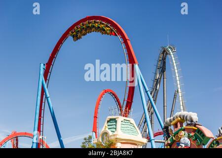 Dragon Khan, Port Aventura World, Salou, Spanien. Schöne Aufnahme des Zuges mit Fahrern auf dem Kopf in einem riesigen Looping. Sonniger Sommertag. August 2019. Stockfoto