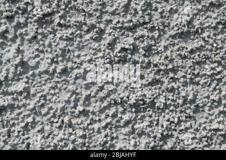 Zementputz auf Betonwand. Grauer Hintergrund. Stockfoto