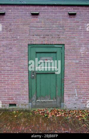 Tür am Elektrizitätsgebäude mit Schild mit der Aufschrift GEFAHR (levensgevaarlijk) Stockfoto