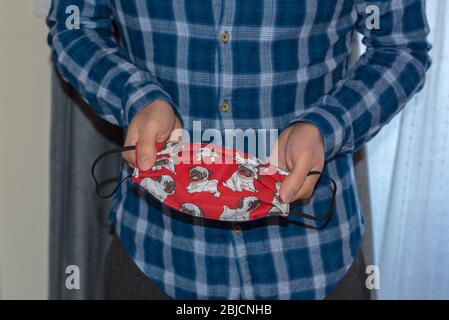 Mann mit Gesichtsmaske besorgt über den Ausbruch von Covid-19 zu Hause bleiben. Stockfoto