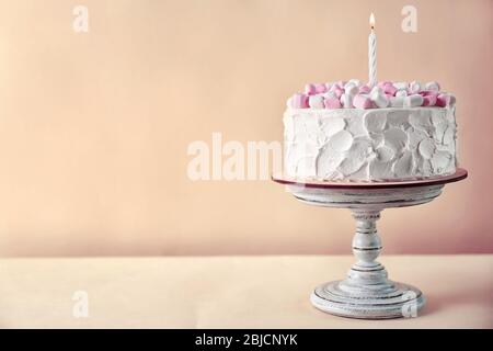 Geburtstagskuchen mit Marshmallows auf farbigem Hintergrund Stockfoto