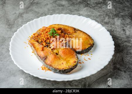 Tiefgebratene Pangasius Fisch mit schwarzem Pfeffer Knoblauch und Fischquelle, schnell und einfach Gericht. Stockfoto