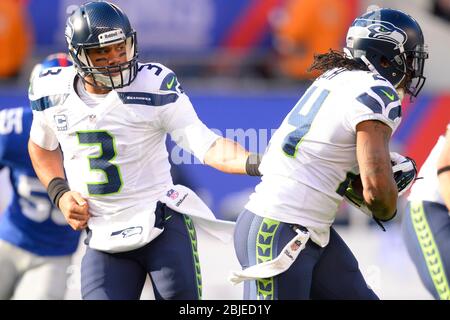 15. Dezember 2013: Seattle Seahawks Quarterback Russell Wilson (3) übergibt sich an Seattle Seahawks, die während des ersten hal Marshawn Lynch (24) zurücklaufen Stockfoto
