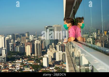 Quarantäne. Der reife Mann zu Hause schaut aus dem Fenster. Stockfoto