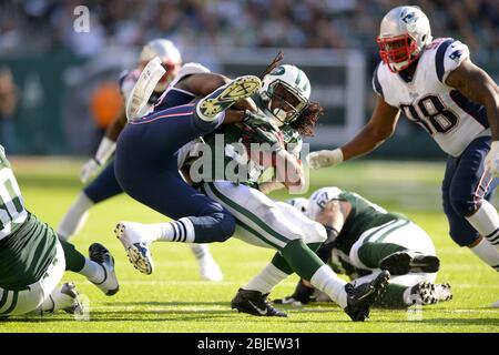 20. Oktober 2013: New York Jets auf dem Rückweg Chris Ivory (33) wird von New England Patriots Defensive End Chandler Jones (95) im zweiten hart getroffen Stockfoto