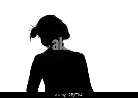 Schwarz hintergrundbeleuchtete Silhouette von Kopf und Schultern einer orientalischen Frau aus der Rückansicht durch Licht umrissen Stockfoto