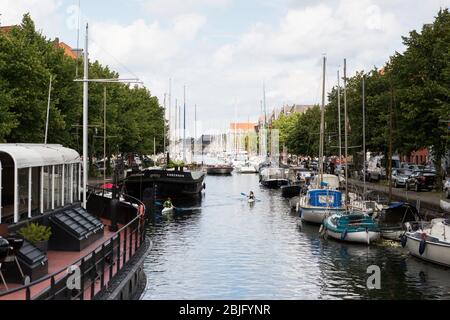 Die Aussicht auf Boote und Kajakfahrer auf dem Kanal von der Brücke bei Sankt Annæ Gade in Kopenhagen, Dänemark, an einem Sommertag. Stockfoto