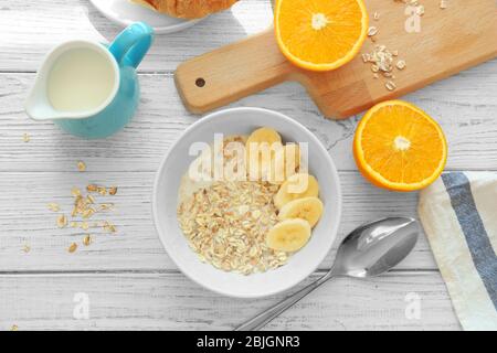 Nahrhaftes Haferbrei zum Frühstück auf Holztisch serviert Stockfoto