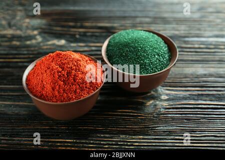 Verschiedene bunte Superfood Pulver in Schalen auf Holztisch Stockfoto