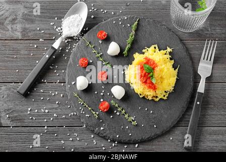 Leckerer Spaghetti-Squash auf Schieferteller Stockfoto