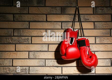 Boxhandschuhe auf Ziegelmauer Stockfoto