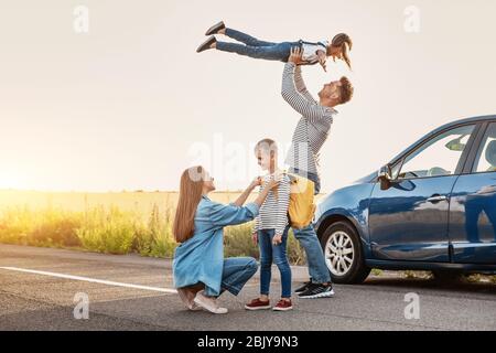 Eltern Abschied von ihren Kindern in der Nähe von Auto Stockfoto