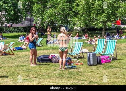 Eine Vielzahl von Sonnenanbetern im Green Park, London, England, Großbritannien. Stockfoto