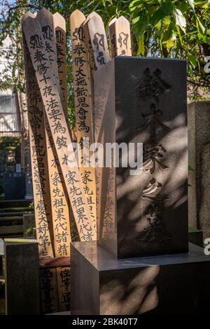 Hölzerne Sotoba und Grabsteine mit Gravuren auf einem Friedhof, Tokio, Japan Stockfoto