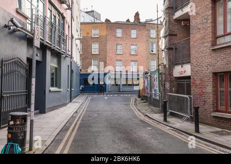 Dublin, Irland - 16. Februar 2019: Menschen, die an einem Wintertag eine kleine Straße mit typischer Architektur der kleinen Innenstadt entlang gehen Stockfoto