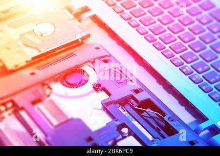 Nahaufnahme auf elektronischem Motherboard, Neonlicht, Hardware-Reparatur-Shop. Verschwommenes Panoramabild mit geöffnetem Notebook-Schaltkreis, Nahaufnahme der Elektronik. Bis Stockfoto