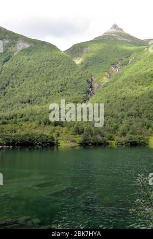 Der Lygnstøylvatnet-See im Norangsdal-Tal in Norwegen wurde 1908 durch einen Felssturz gebildet. Die Fundamente verlassene Bauernhäuser sind noch sichtbar Stockfoto