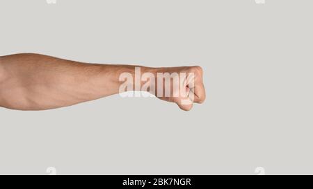 Millennial Mann zusammenschlingende Faust auf hellgrauem Hintergrund, Nahaufnahme. Kopierbereich. Panorama Stockfoto