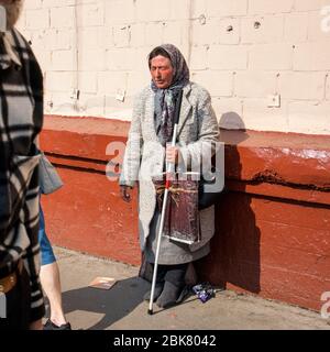 Moskau, Russland - 1. Mai 2019, EINE Frau mit versiegelten Augen, die sich als blind vorgibt, mit einem Stock in der Hand, bittet um Almosen auf der Straße. Mafia von b Stockfoto