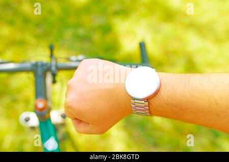 Man führt im Sommer das Radtraining mit einer Smart Watch auf dem Offroad durch. Isoliert Stockfoto