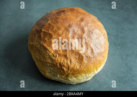 Frisch gebackenes Rundbrot auf Betongrund. Gesunde, köstliche und hausgemachte Speisen. Stockfoto