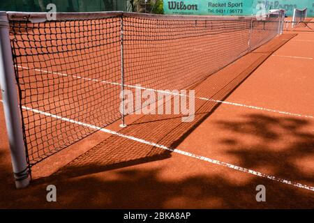 Kiel, Deutschland. Mai 2020. Auf einem Tennisplatz im Ravensberger Ortsteil wird ein Netz gespannt. Ab dem 4. Mai 2020 kann in Schleswig-Holstein Tennis als Einzelspiel unter strengen Hygienevorschriften gespielt werden. Aufgrund des Kontaktverbots ist jede Form der Begrüßung der Spieler mit körperlichem Kontakt verboten. Der Mindestabstand von 1.5 Metern muss jederzeit eingehalten werden. Quelle: Frank Molter/dpa/Alamy Live News Stockfoto