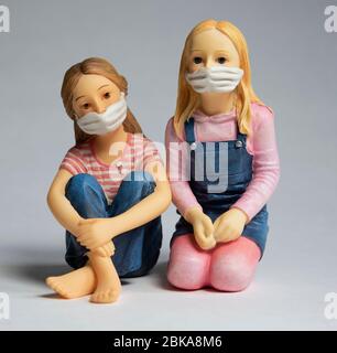 Zwei Kinder tragen Gesichtsmasken, Covid-19, Corona-Virenschutz, Miniaturfiguren Stockfoto