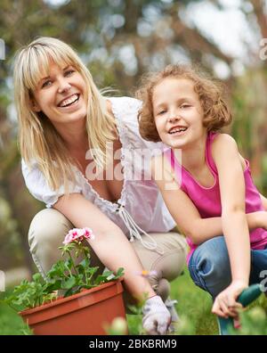 Glückliche Familie Gartenarbeit im Frühling im Garten Stockfoto