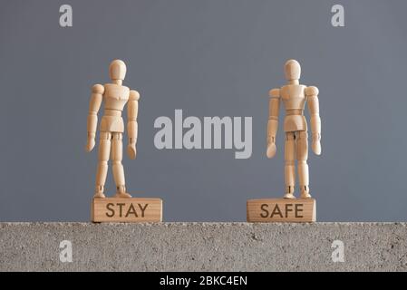 Bild über die Notwendigkeit der Selbstversorgung, in Bezug auf den Ausbruch des Coronavirus, covid-19. Holzfiguren auf Blöcken mit dem Text bleiben sicher. Stockfoto