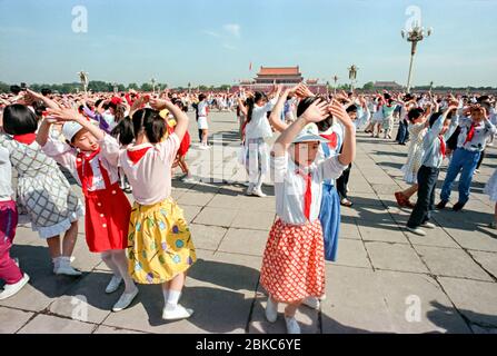 Chinesische junge Pioniere, Tanz während der Feierlichkeiten zum Internationalen Kindertag, die am 2. Juni 1990 auf dem Platz des Himmlischen Friedens in Peking, China, abgehalten werden. Die Veranstaltung wurde als Ablenkung vom Jahrestag des Massakers abgehalten, bei dem Studenten-geführte Demokratieprotestierende am 4. Juni 1989 getötet wurden. Stockfoto