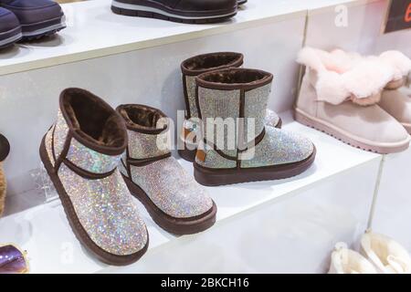 Silber UGG im Schaufenster, Damen Winter warme Schuhe. Winterkleidung, Mode und kalte Jahreszeit Konzept. Stockfoto