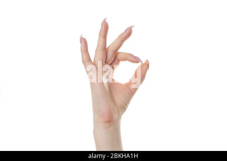 Schöne weibliche Hand gestikulierend. Okay Symbol. Auf weissem Hintergrund. Stockfoto