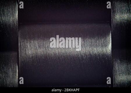 Extreme Makroaufnahme eines schwarzen Metallarmbands für eine Uhr Stockfoto